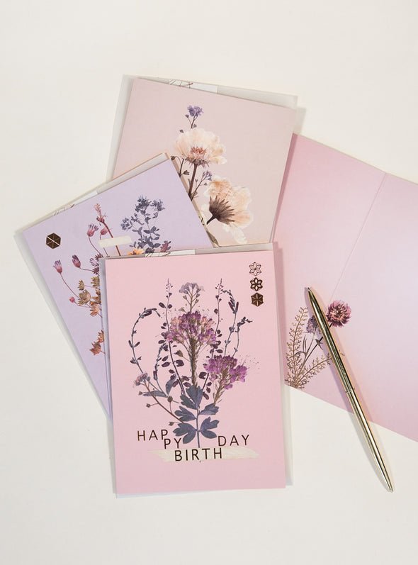greeting cards with pen on table