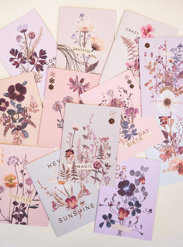 several pink petal greeting cards on table