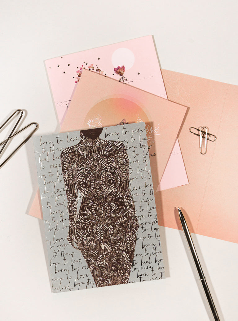 greeting cards with pen on table